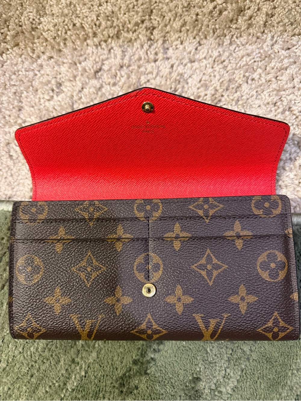 Louis Vuitton Monogram Continental Wallet with Red Interior
She is the SARAH